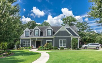 green lawn in front of suburban home on a sunny day