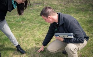 lawn consultant meeting with homeowner addressing lawn disease control options for their yard